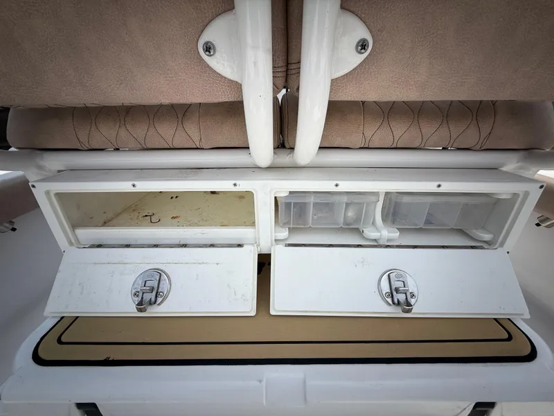 Slide: The Image of 2020 Sportsman Masters 247 Bay Boat storage compartments with secure latches and cushioned seating. - 17