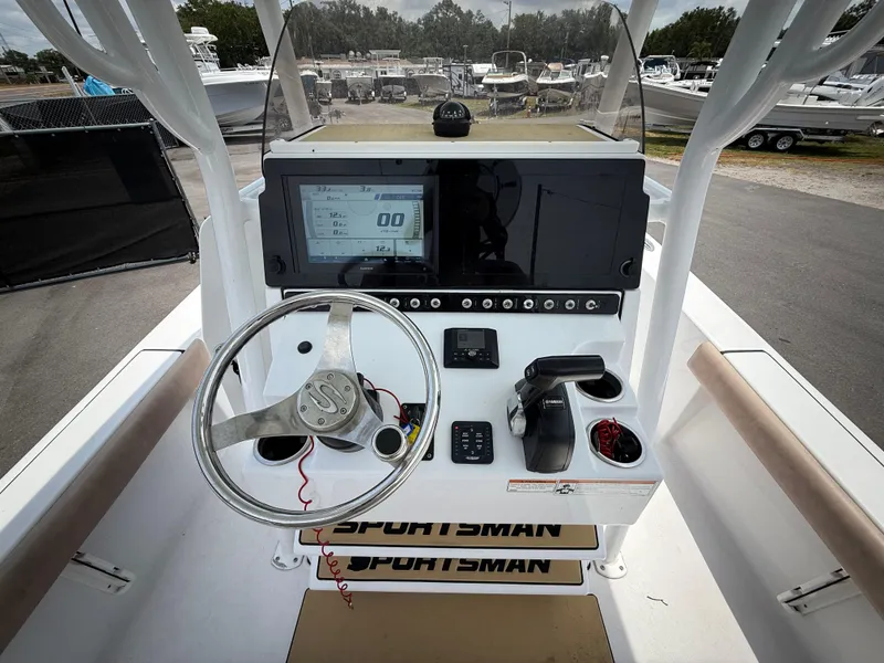 Slide: The Image of 2020 Sportsman Masters 247 Bay Boat dashboard with steering wheel and electronic controls. - 20
