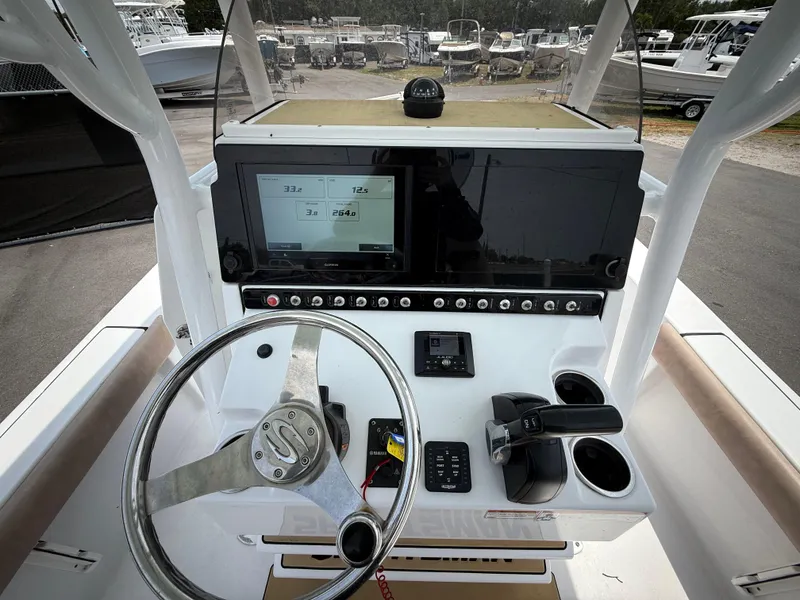 Slide: The Image of 2020 Sportsman Masters 247 Bay Boat dashboard with steering wheel and navigation display. - 21