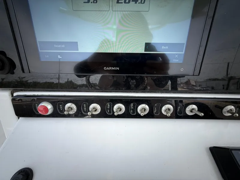 Slide: The Image of Control panel of a 2020 Sportsman Masters 247 Bay Boat with Garmin display and switches. - 23