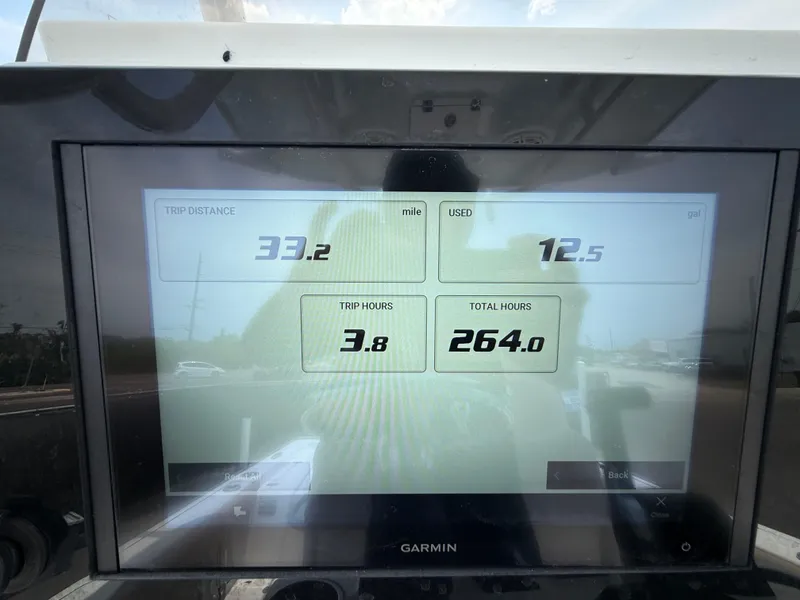 Slide: The Image of Garmin display on 2020 Sportsman Masters 247 Bay Boat showing trip data and hours. - 24