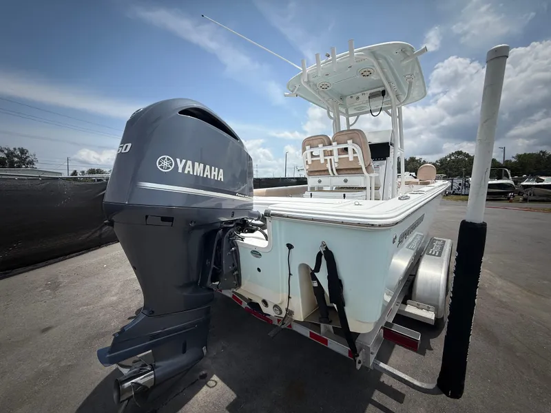 Slide: The Image of 2020 Sportsman Masters 247 Bay Boat with Yamaha engine on trailer, under cloudy sky. - 4