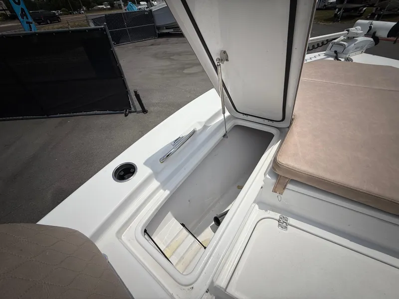 Slide: The Image of 2020 Sportsman Masters 247 Bay Boat storage compartment with open lid, showcasing spacious interior. - 41