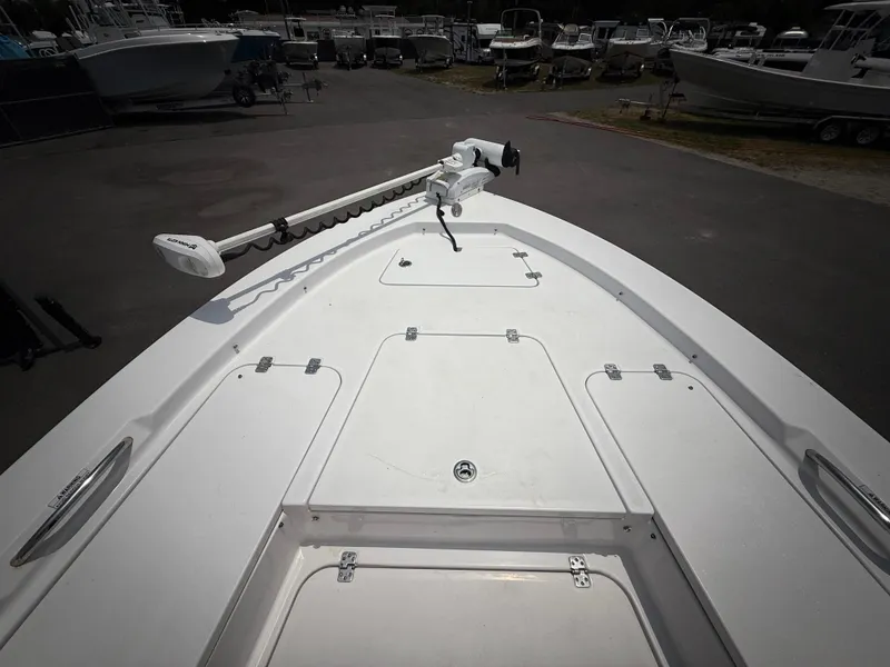 Slide: The Image of 2020 Sportsman Masters 247 Bay Boat deck with trolling motor in a marina. - 44