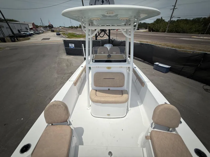 Slide: The Image of 2020 Sportsman Masters 247 Bay Boat with seating and T-top, parked on pavement. - 49