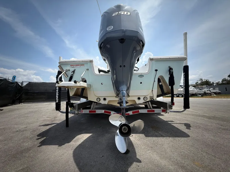 Slide: The Image of 2020 Sportsman Masters 247 Bay Boat rear view with powerful outboard motor. - 6
