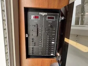 Slide: The Image of Electrical control panel on 2018 Invincible 42 CC boat, featuring switches and digital displays. - 10