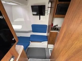 Slide: The Image of Interior of 2018 Invincible 42 CC boat with seating, TV, and kitchenette. - 13