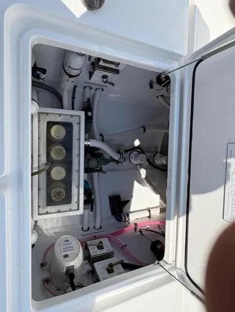 Slide: The Image of 2018 Invincible 42 CC boat compartment with wiring and mechanical components. - 23