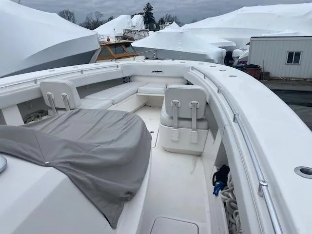 Slide: The Image of 2018 Invincible 42 CC boat with covered seating, docked in a marina. - 5