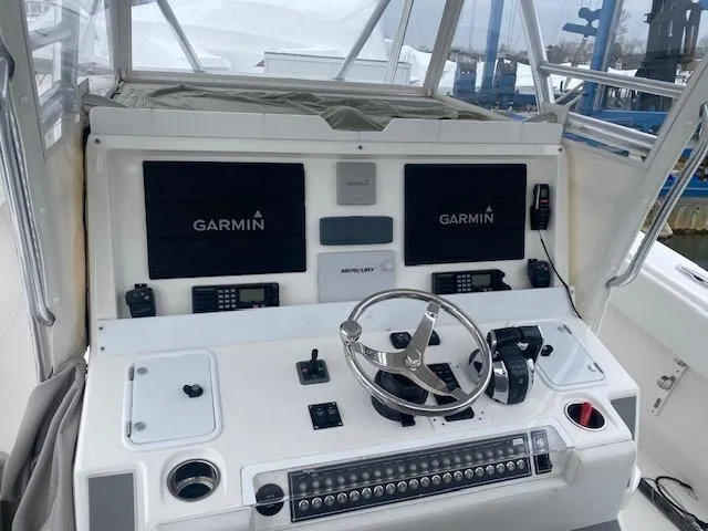Slide: The Image of Control panel of 2018 Invincible 42 CC boat with Garmin displays and steering wheel. - 7