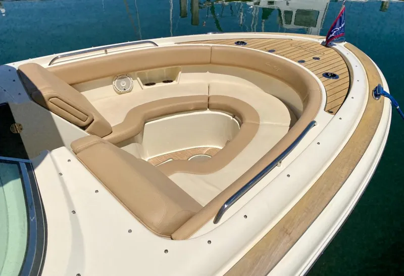 Slide: The Image of 2020 Chris-Craft Calypso 26 boat with luxurious tan seating and wooden deck. - 13