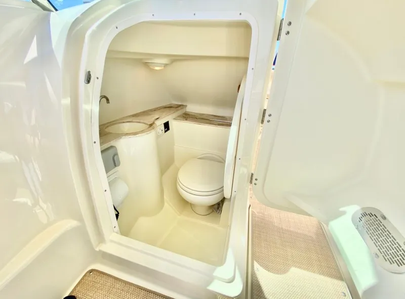 Slide: The Image of 2020 Chris-Craft Calypso 26 boat interior bathroom with toilet and sink. - 21