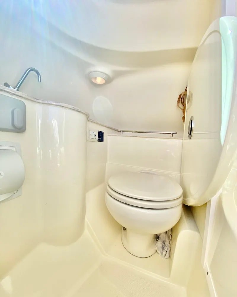 Slide: The Image of 2020 Chris-Craft Calypso 26 boat bathroom interior with toilet and sink. - 22
