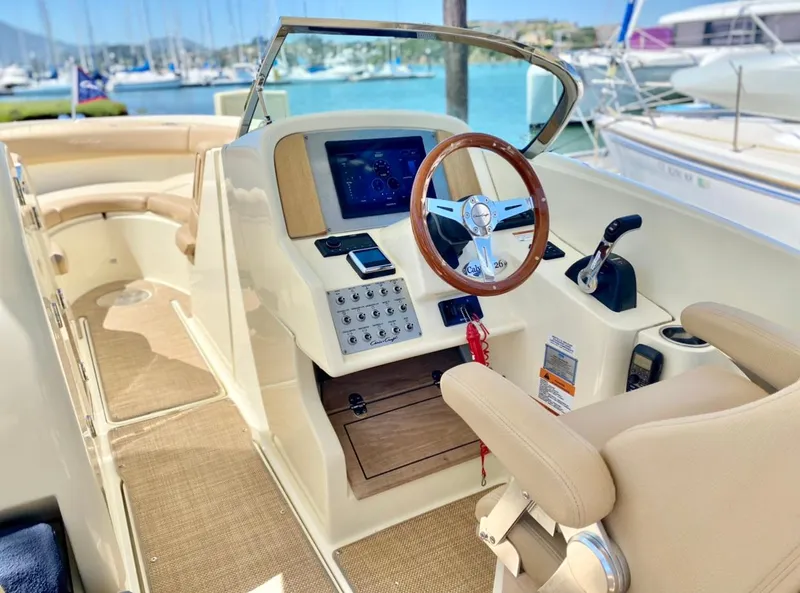 Slide: The Image of 2020 Chris-Craft Calypso 26 boat interior with steering wheel and control panel. - 23