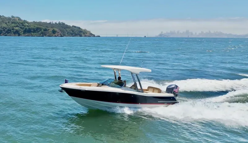Slide: The Image of 2020 Chris-Craft Calypso 26 cruising on open water, showcasing sleek design and performance. - 28