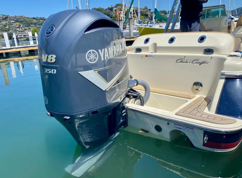 Slide: The Image of 2020 Chris-Craft Calypso 26 with Yamaha V8 350 outboard engine at a marina. - 32