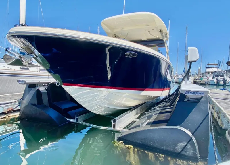 Slide: The Image of 2020 Chris-Craft Calypso 26 boat docked in marina, reflecting on water. - 35