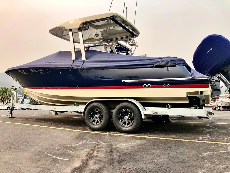 Slide: The Image of 2020 Chris-Craft Calypso 26 boat on trailer, covered and parked outdoors. - 37