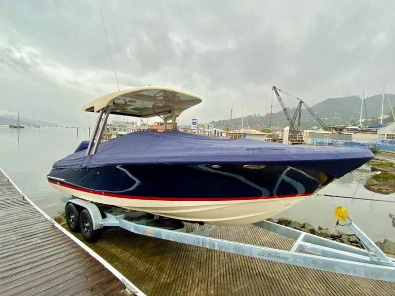 Slide: The Image of 2020 Chris-Craft Calypso 26 boat on trailer, covered, dockside view. - 38