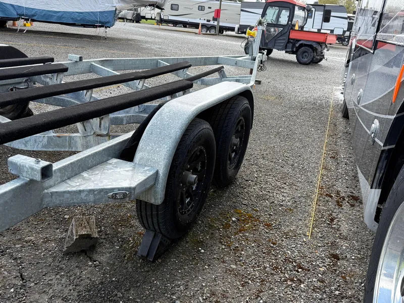 Slide: The Image of Trailer for 2020 Chris-Craft Calypso 26 boat in a parking area. - 42