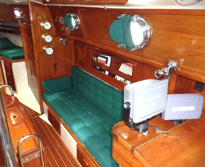 Slide: The Image of Interior of 1987 Pacific Seacraft 34 sailboat with green upholstery and wooden finish. - 2