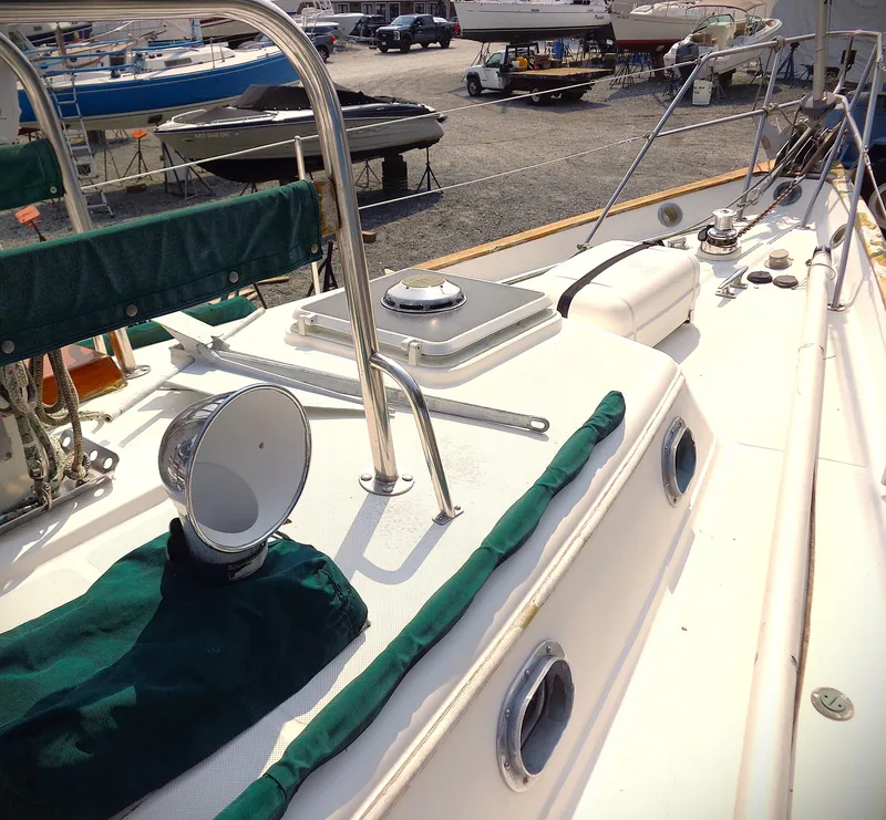 Slide: The Image of 1987 Pacific Seacraft 34 sailboat deck with chrome fittings and green canvas covers. - 4