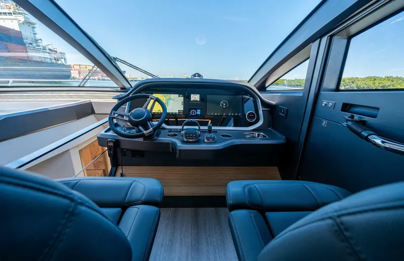 Slide: The Image of Interior cockpit of 2023 Pearl 62 yacht, featuring modern controls and luxurious seating. - 10