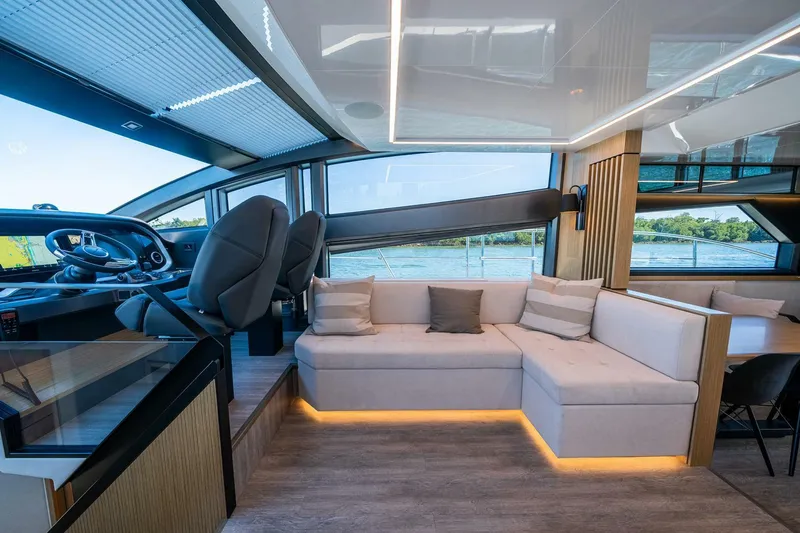 Slide: The Image of Luxurious interior of 2023 Pearl 62 yacht with modern seating and panoramic windows. - 11
