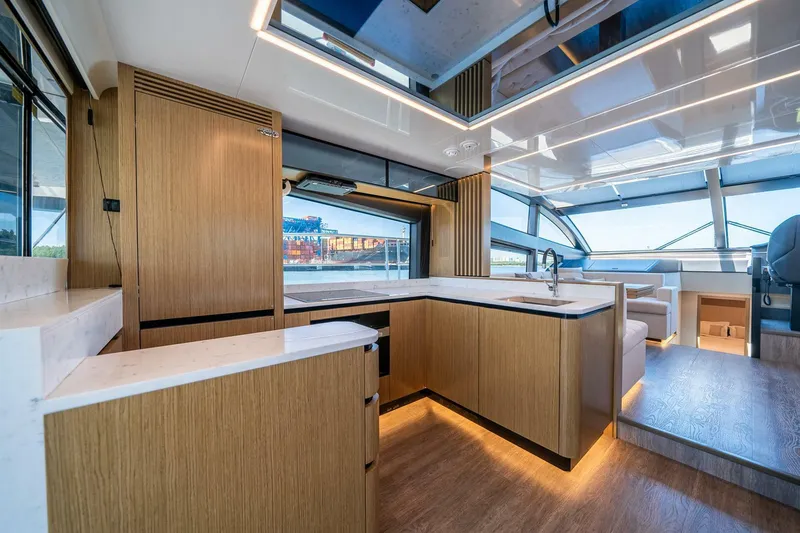 Slide: The Image of Luxurious interior of 2023 Pearl 62 yacht with modern kitchen and panoramic windows. - 12