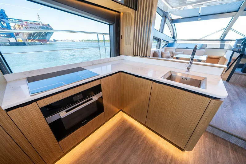 Slide: The Image of Modern kitchen interior on 2023 Pearl 62 yacht with sleek design and waterfront view. - 14