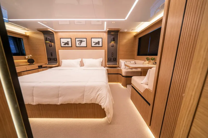 Slide: The Image of Luxurious bedroom interior of 2023 Pearl 62 yacht with modern wood finishes and ambient lighting. - 17