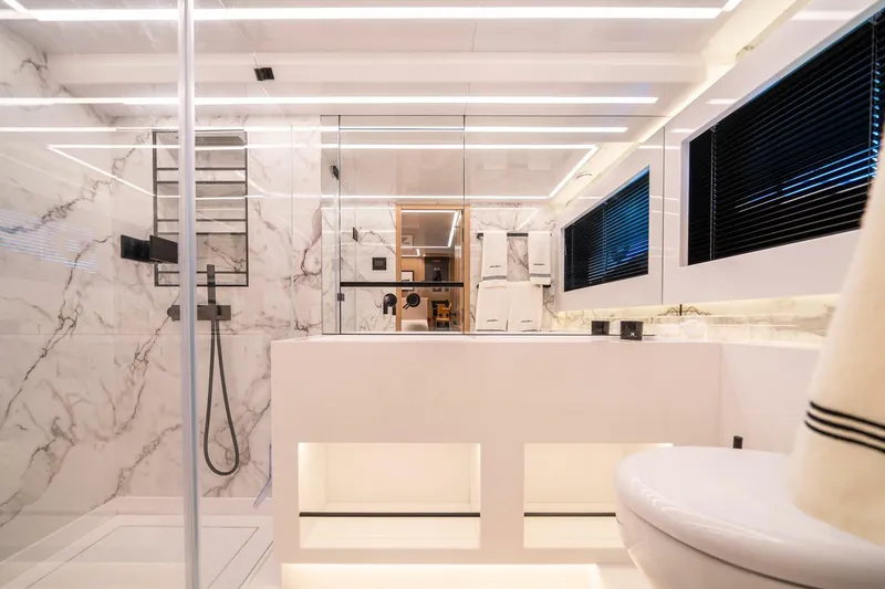 Slide: The Image of Luxurious modern bathroom with marble walls, sleek fixtures, and ambient lighting in a Pearl 62 yacht. - 22