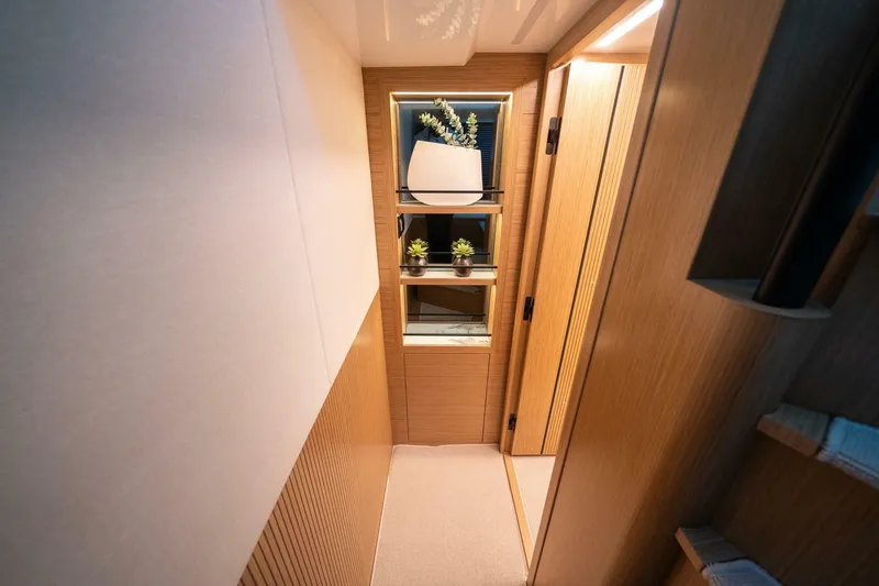 Slide: The Image of Modern interior of 2023 Pearl 62 yacht with elegant wooden paneling and decorative plants. - 25