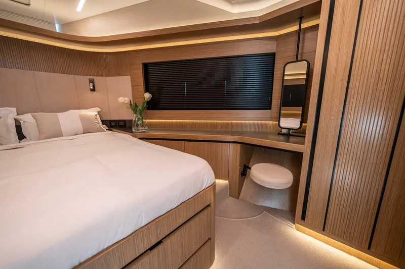 Slide: The Image of Luxurious 2023 Pearl 62 yacht bedroom with modern wood paneling and elegant decor. - 26