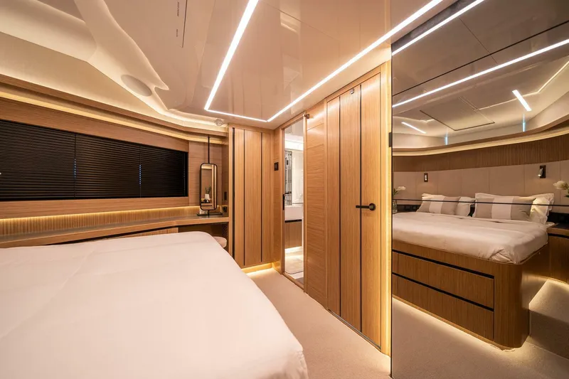 Slide: The Image of Luxurious interior of 2023 Pearl 62 yacht, featuring modern wood paneling and ambient lighting. - 27