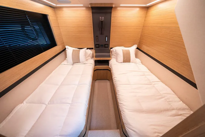 Slide: The Image of Luxurious twin cabin interior of 2023 Pearl 62 yacht with modern wood paneling. - 28