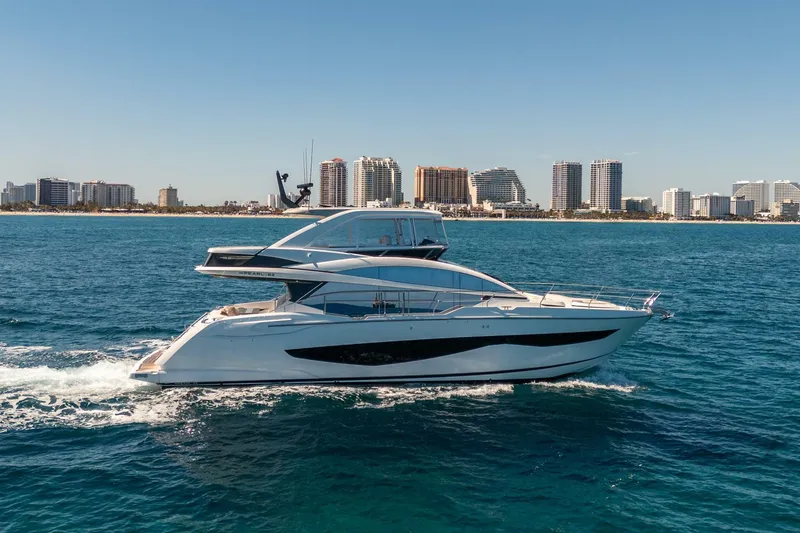 Slide: The Image of 2023 Pearl 62 yacht cruising near city skyline on a sunny day. - 3