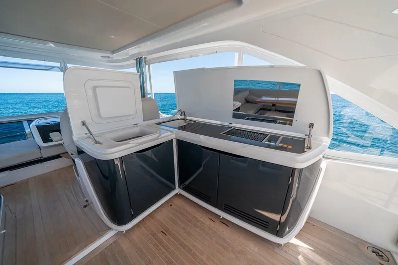 Slide: The Image of Luxurious 2023 Pearl 62 yacht interior with modern kitchen and ocean view. - 40