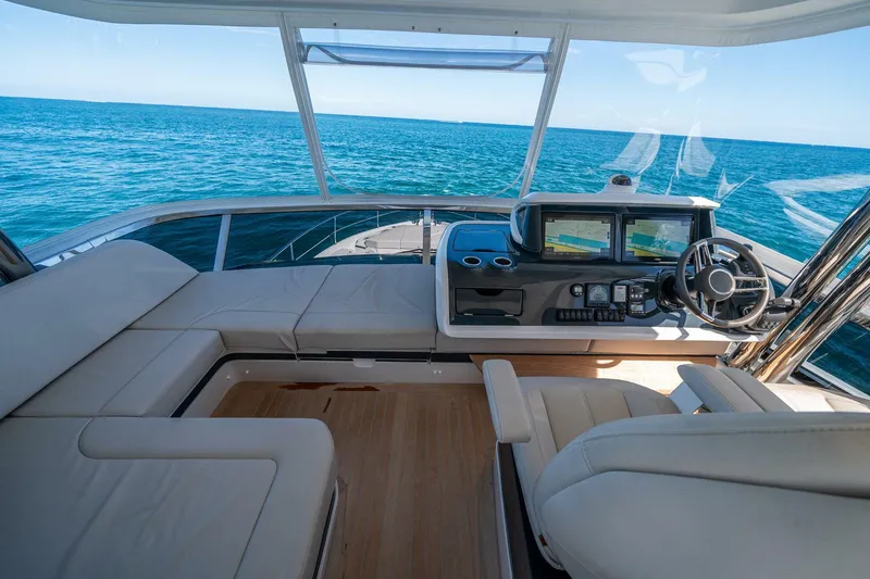 Slide: The Image of Luxurious 2023 Pearl 62 yacht interior with ocean view, featuring modern helm and seating. - 41