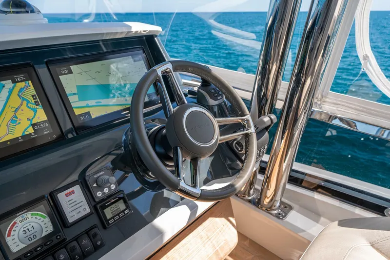 Slide: The Image of Steering wheel and navigation system of 2023 Pearl 62 yacht on open sea. - 42