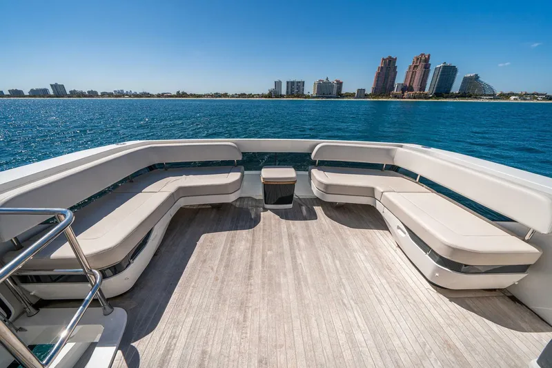 Slide: The Image of Luxurious Pearl 62 yacht deck with seating, overlooking a serene waterfront cityscape, 2023 model. - 46