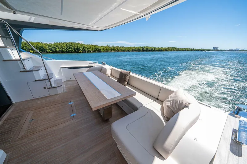 Slide: The Image of 2023 Pearl 62 yacht with elegant deck seating and scenic ocean view. - 48