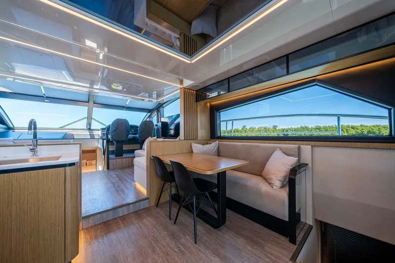 Slide: The Image of Luxurious interior of 2023 Pearl 62 yacht with modern seating and panoramic windows. - 6