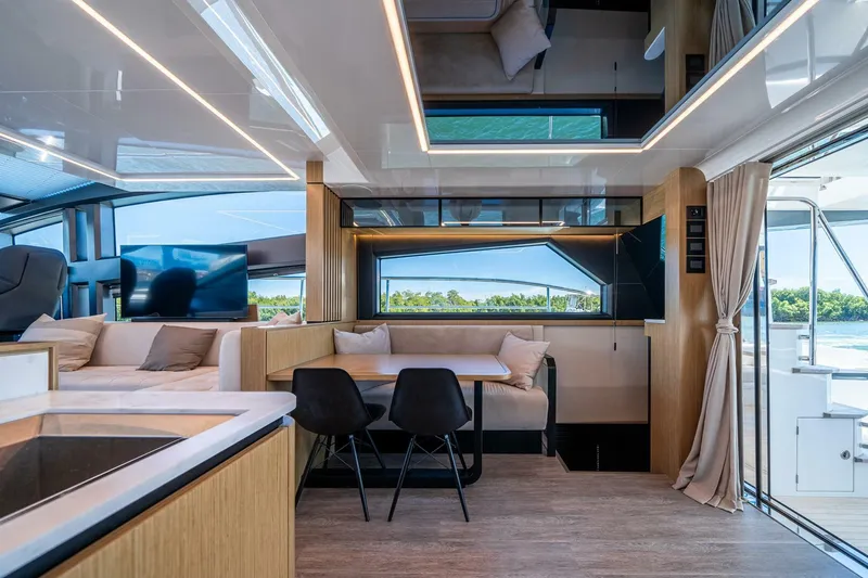 Slide: The Image of Luxurious interior of 2023 Pearl 62 yacht with modern seating and large windows. - 8