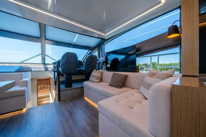 Slide: The Image of Luxurious interior of 2023 Pearl 62 yacht with modern seating and panoramic windows. - 9