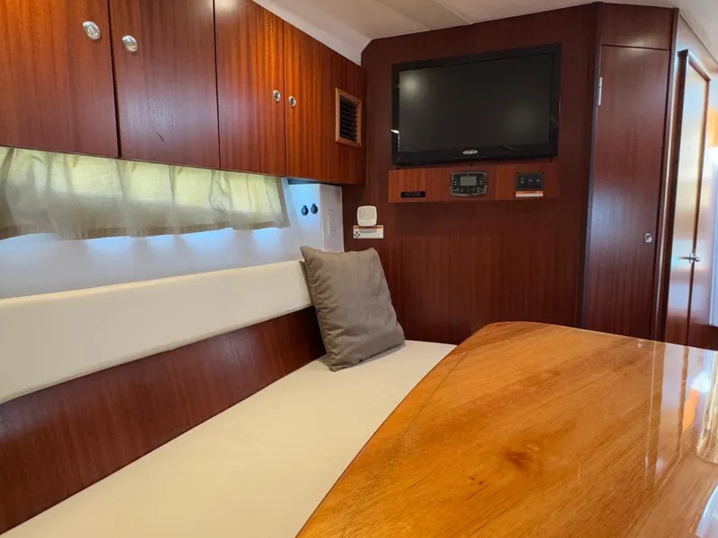 Slide: The Image of Interior of 2015 Pursuit SC 365i Sport Coupe with wood finish and seating area. - 11