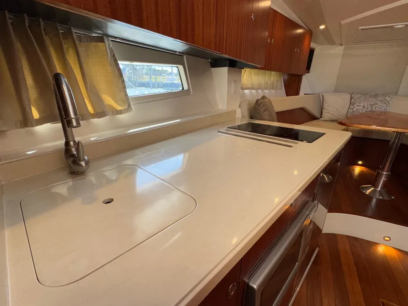 Slide: The Image of 2015 Pursuit SC 365i Sport Coupe interior with modern kitchen and seating area. - 12
