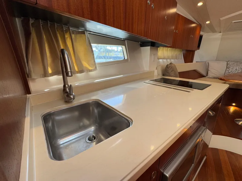 Slide: The Image of Interior of 2015 Pursuit SC 365i Sport Coupe with modern kitchen amenities. - 13