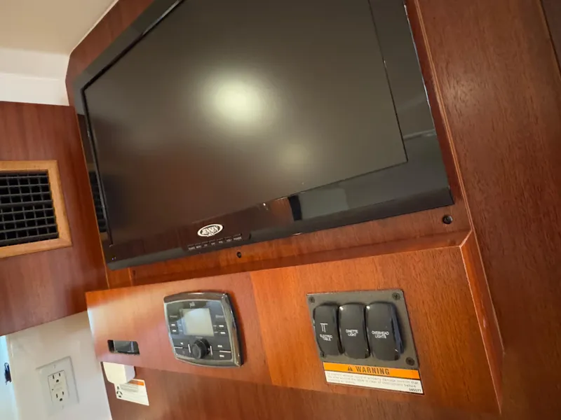 Slide: The Image of Interior of 2015 Pursuit SC 365i Sport Coupe with TV and control panel. - 14